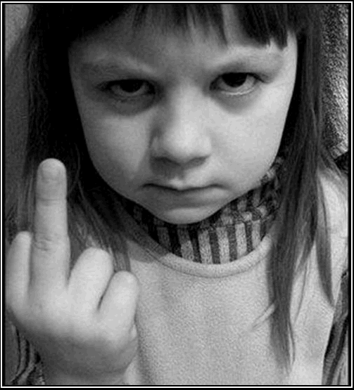 A small, unhappy girl giving the finger.